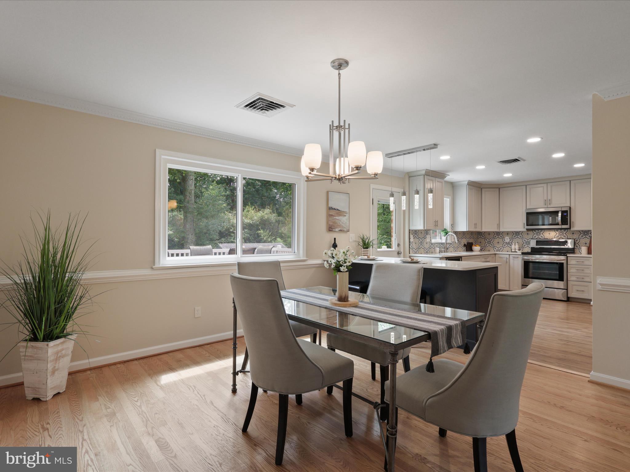 4417 Laurel Road Alexandria, VA 22309 - Photo 9 of 46 a view of a dining room with furniture window and wooden floor