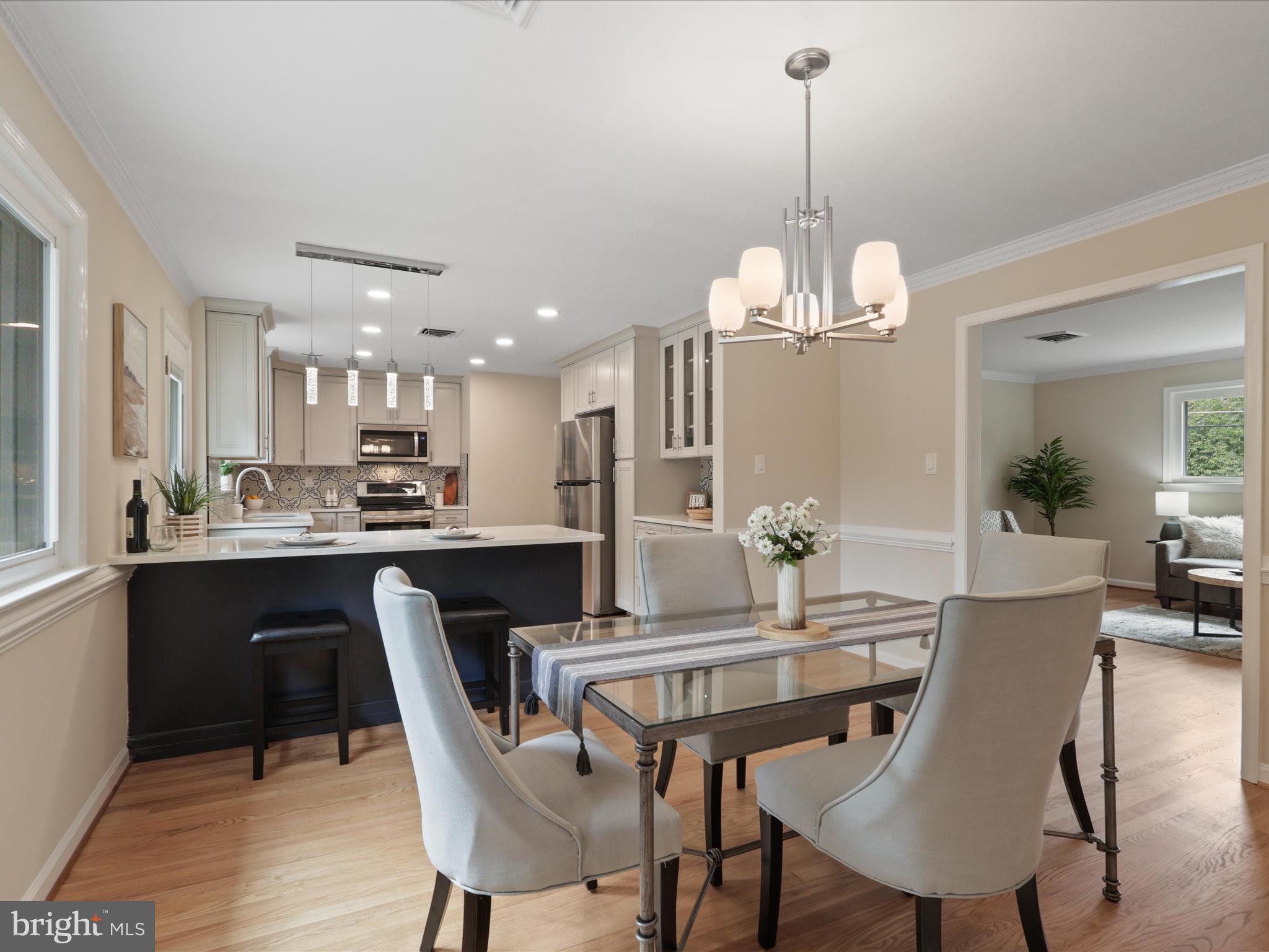 4417 Laurel Road Alexandria, VA 22309 - Photo 42 of 46 a view of a dining room and a kitchen with a dining table chairs