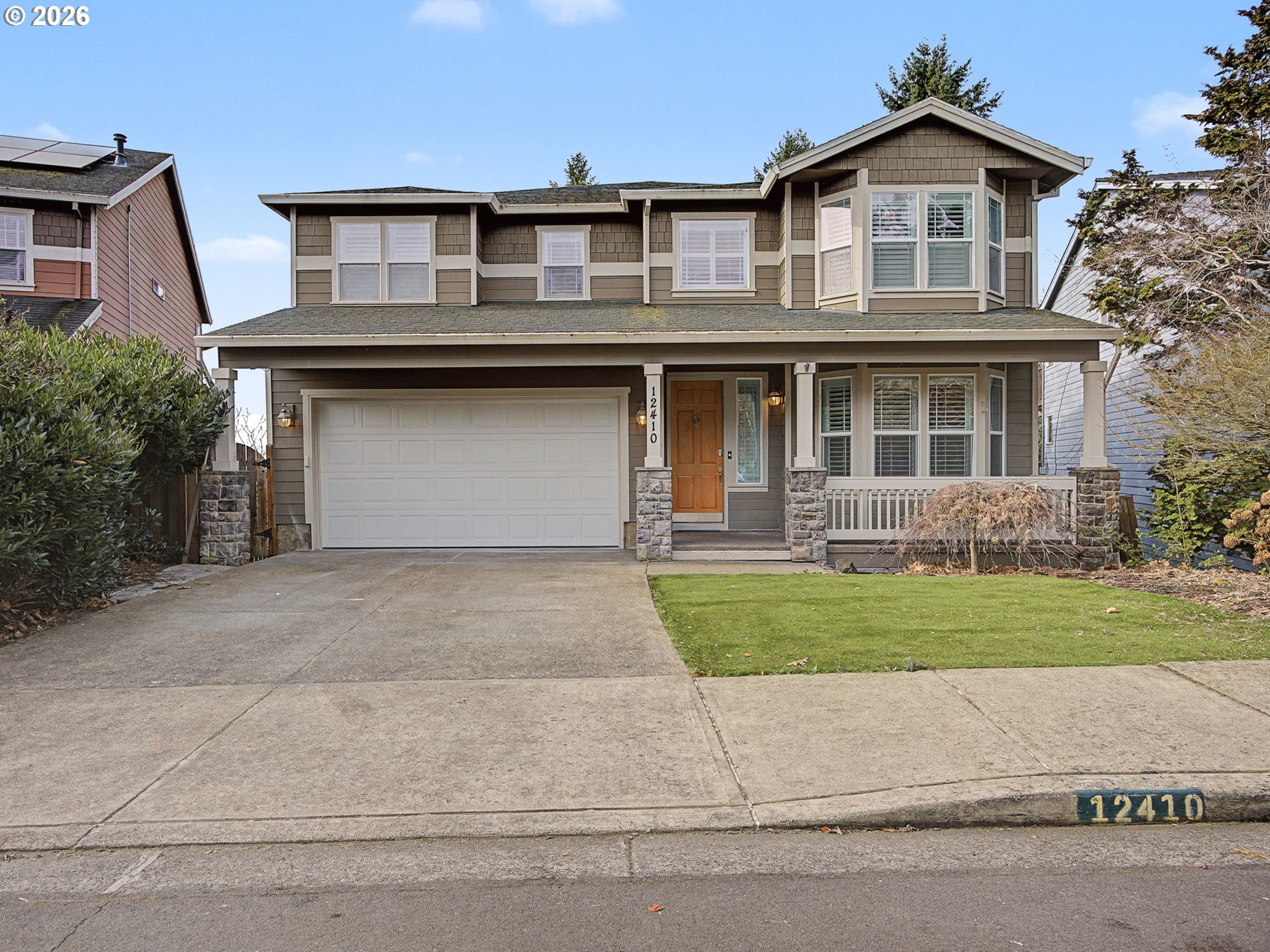 12410 Southwest Aspen Ridge Drive Tigard, OR 97224 - Photo 2 of 47 a front view of a house with a yard and garage