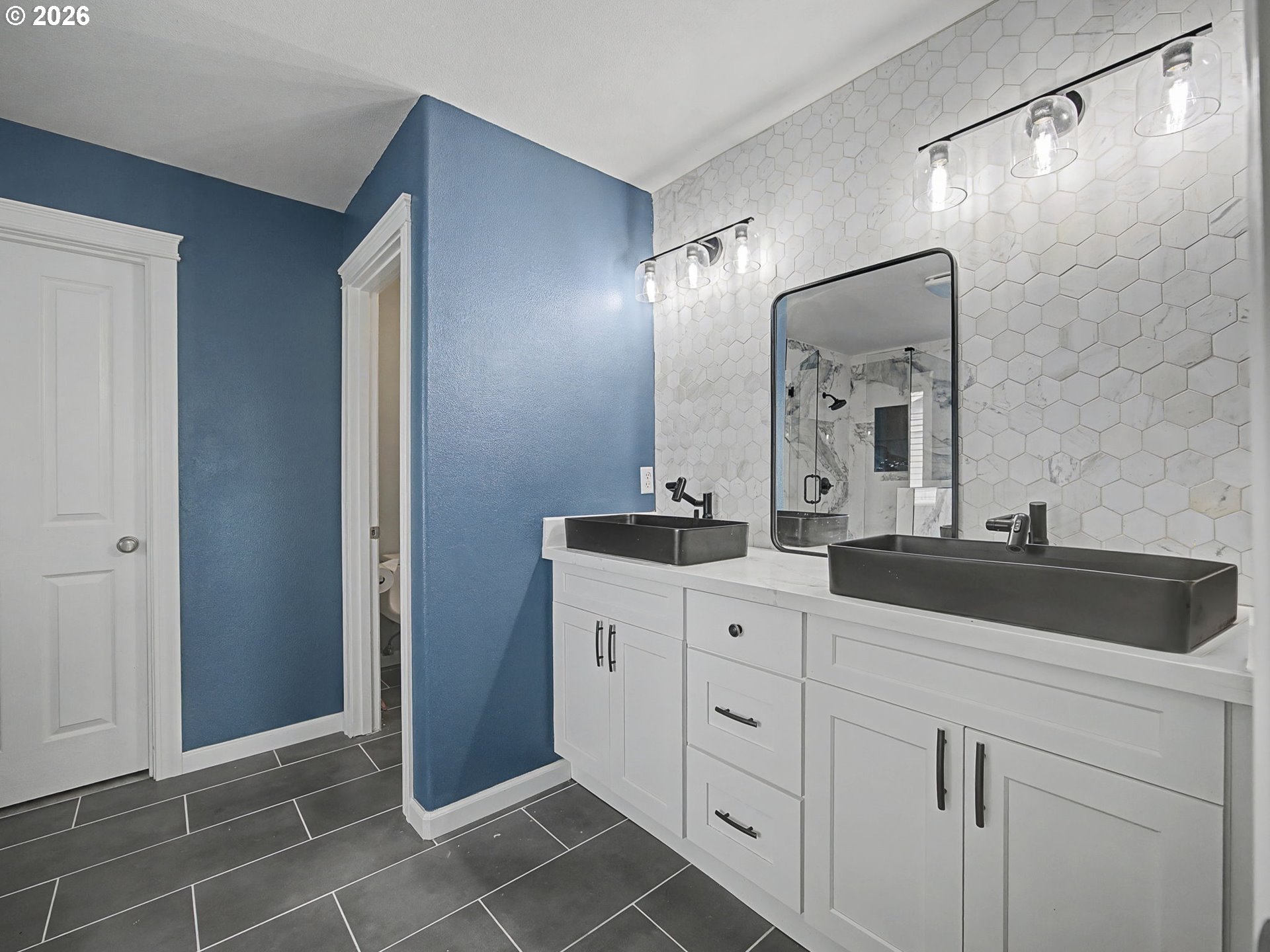 12410 Southwest Aspen Ridge Drive Tigard, OR 97224 - Photo 24 of 47 a bathroom with a double vanity sink mirror and