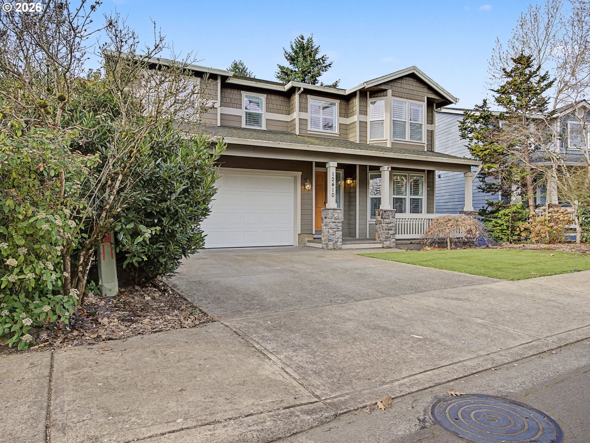 12410 Southwest Aspen Ridge Drive Tigard, OR 97224 - Photo 3 of 47 a front view of house with yard and trees around