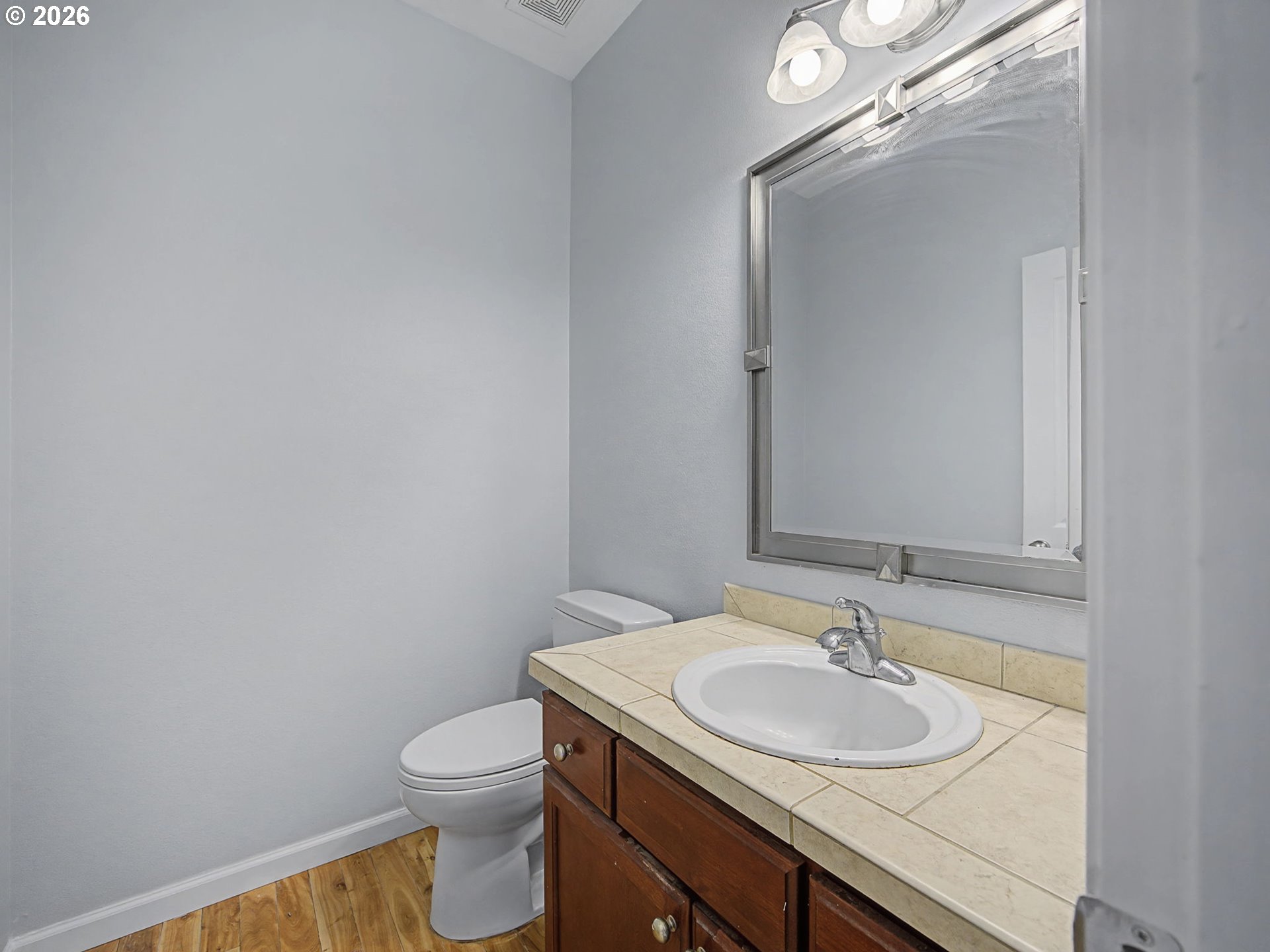 12410 Southwest Aspen Ridge Drive Tigard, OR 97224 - Photo 8 of 47 a bathroom with a granite countertop sink toilet and mirror