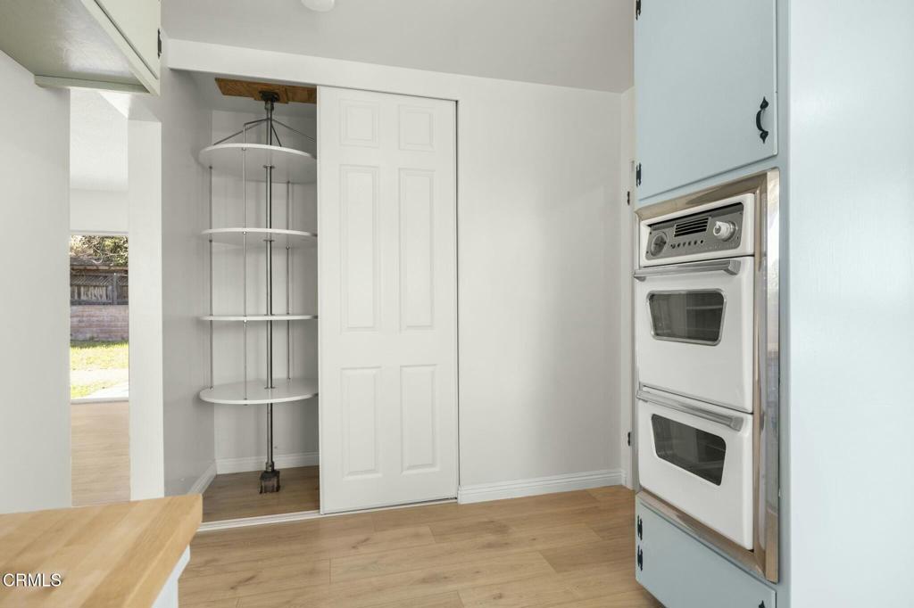 6861 Bristol Road Ventura, CA 93003 - Photo 22 of 42 a kitchen with white cabinets and a refrigerator