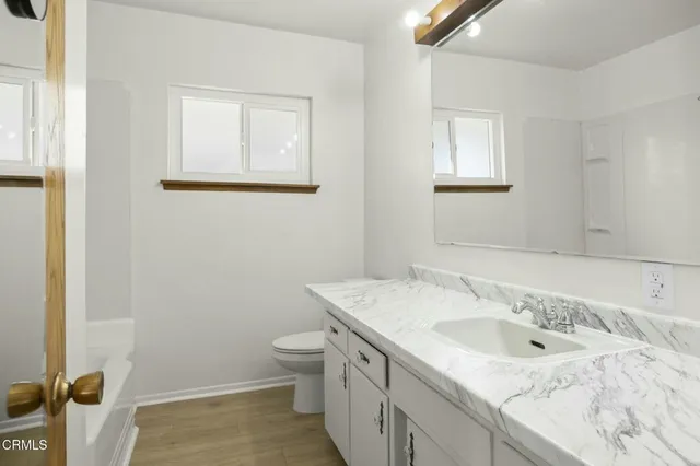 an empty room with a painting on the wall