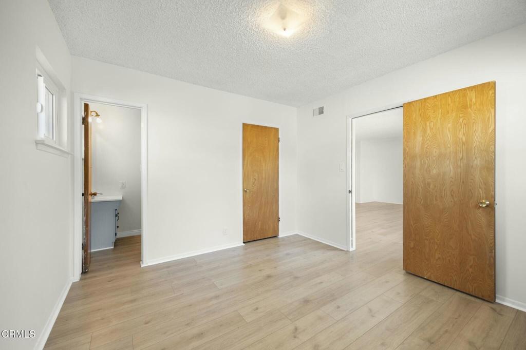 6861 Bristol Road Ventura, CA 93003 - Photo 34 of 42 a view of empty room with wooden floor and bathroom