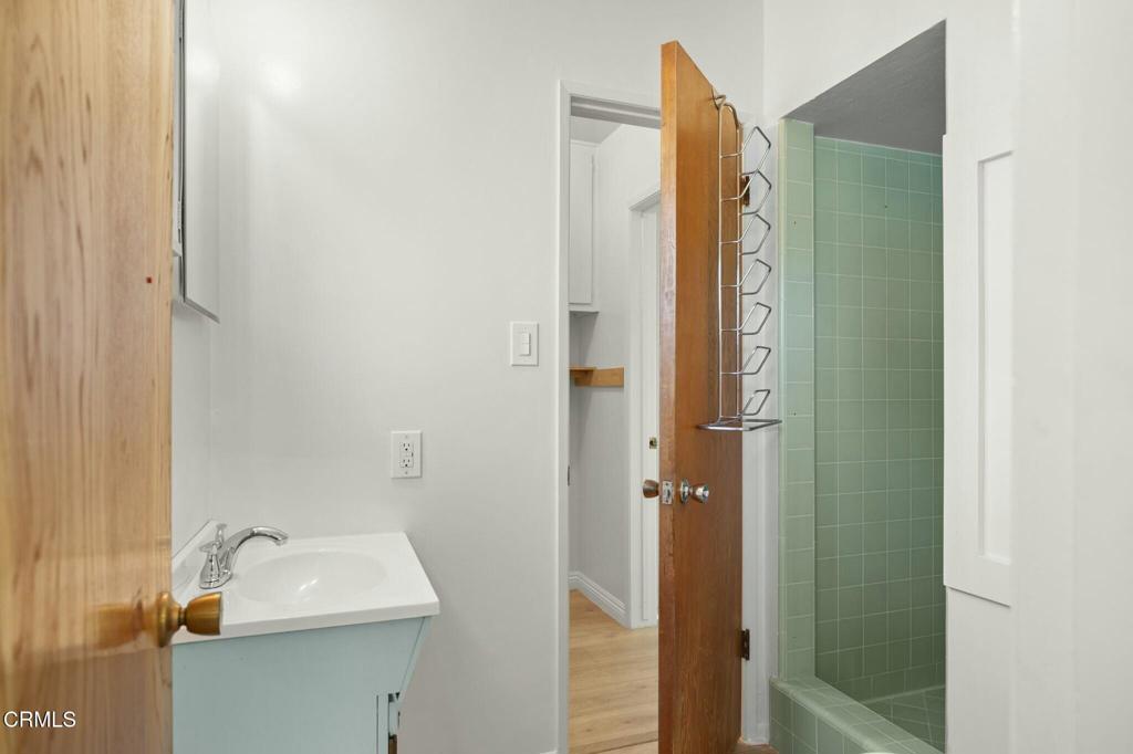 6861 Bristol Road Ventura, CA 93003 - Photo 35 of 42 a bathroom with a sink a mirror and shower