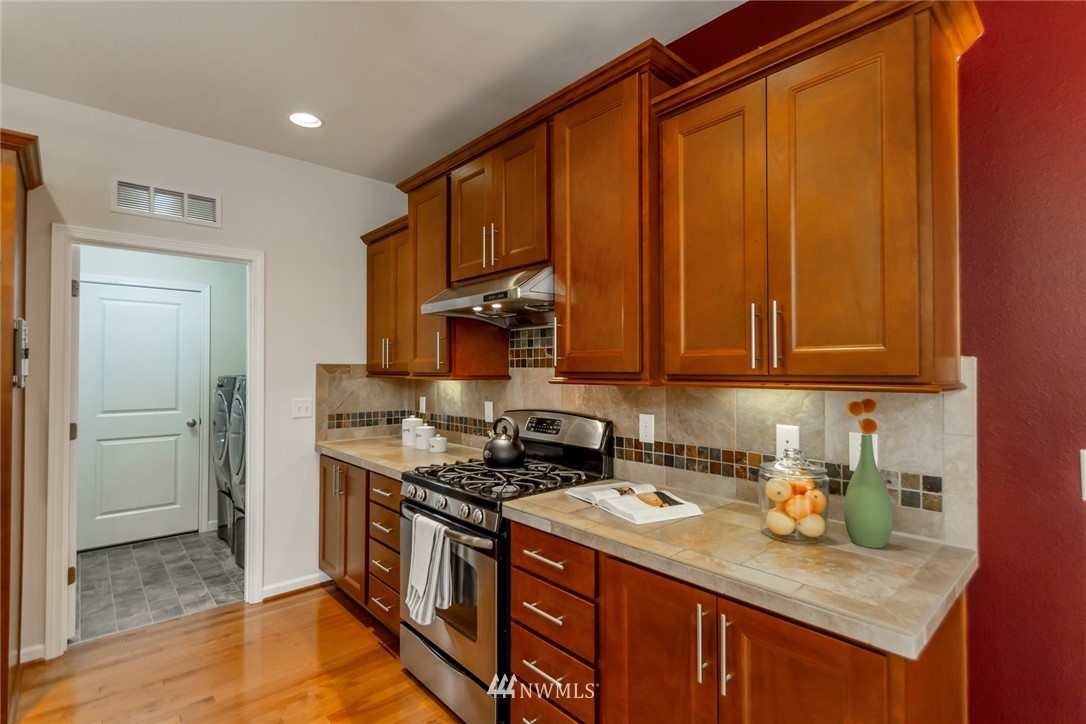 18615 35th Drive Southeast Bothell, WA 98012 - Photo 11 of 30 a kitchen with stainless steel appliances granite countertop a stove a sink and a refrigerator