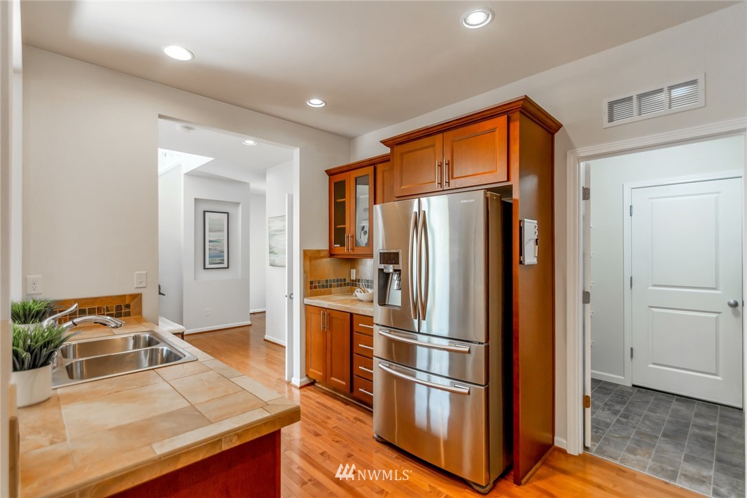 18615 35th Drive Southeast Bothell, WA 98012 - Photo 12 of 30 a kitchen with stainless steel appliances granite countertop a refrigerator and a sink