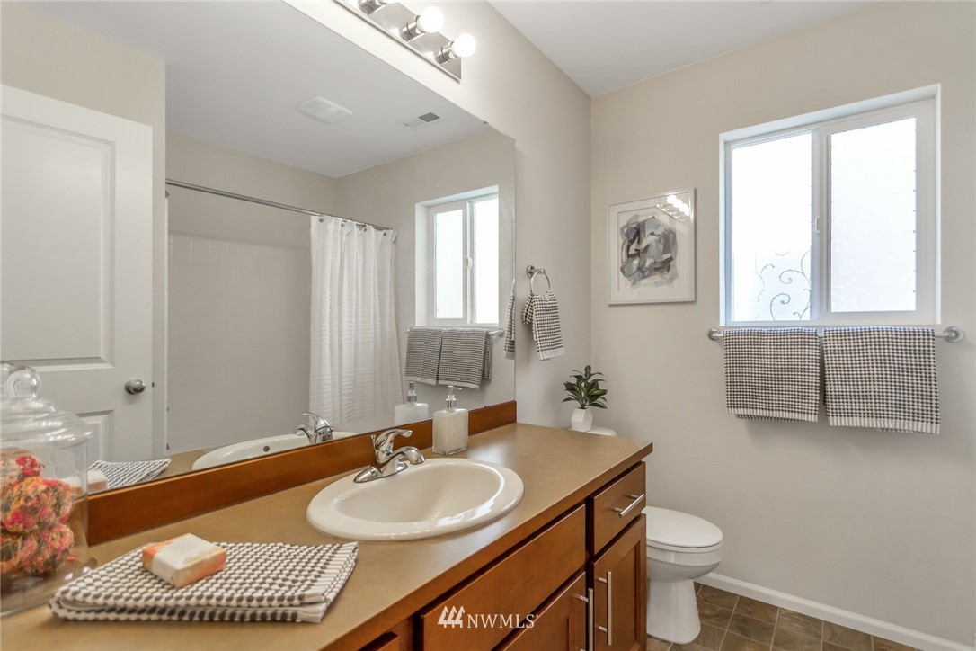 18615 35th Drive Southeast Bothell, WA 98012 - Photo 25 of 30 a bathroom with a sink a toilet and a mirror