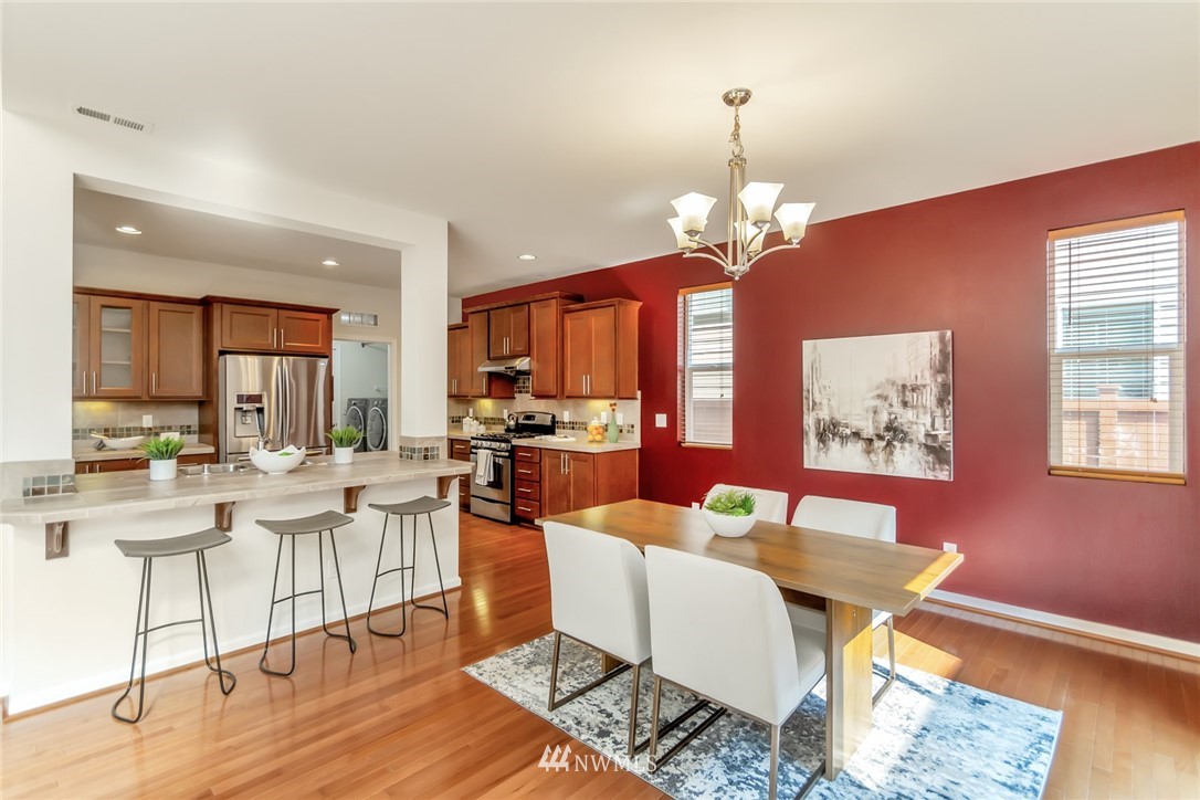 18615 35th Drive Southeast Bothell, WA 98012 - Photo 8 of 30 a view of a dining room with furniture a chandelier and wooden floor