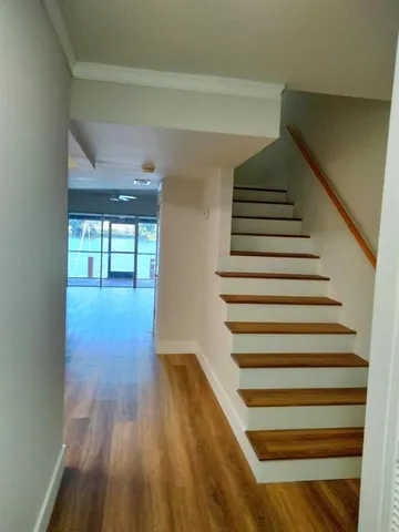 a view of entryway and hall with wooden floor