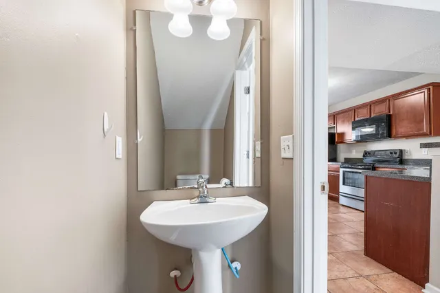 a bathroom with a sink a mirror and a shower