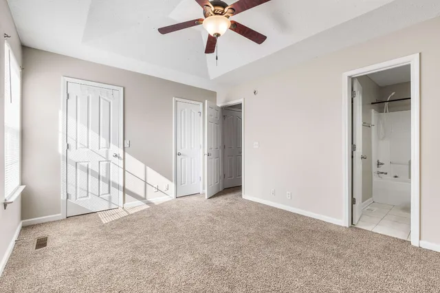 a view of empty room with ceiling fan