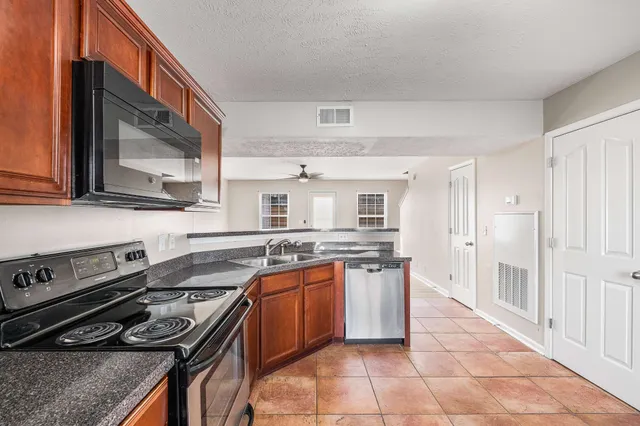 a kitchen with stainless steel appliances granite countertop a stove and a sink