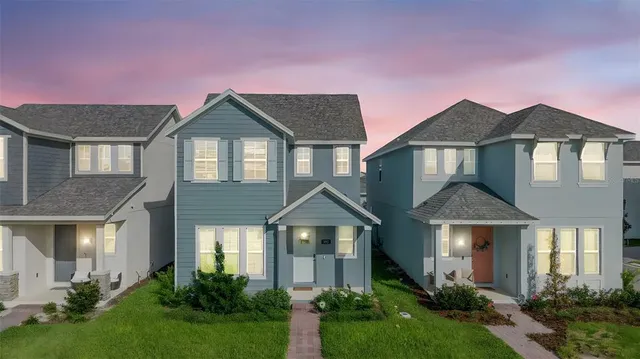 a front view of a house with yard and green space