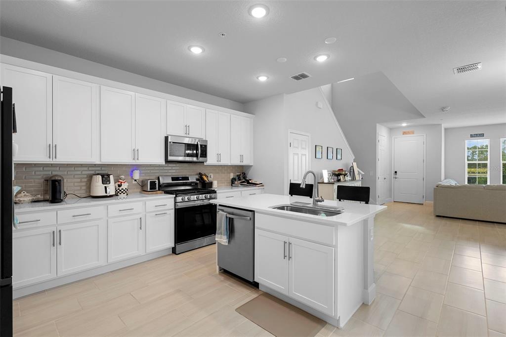 269 Platform Lane DeBary, FL 32713 - Photo 18 of 41 a kitchen with white cabinets and sink