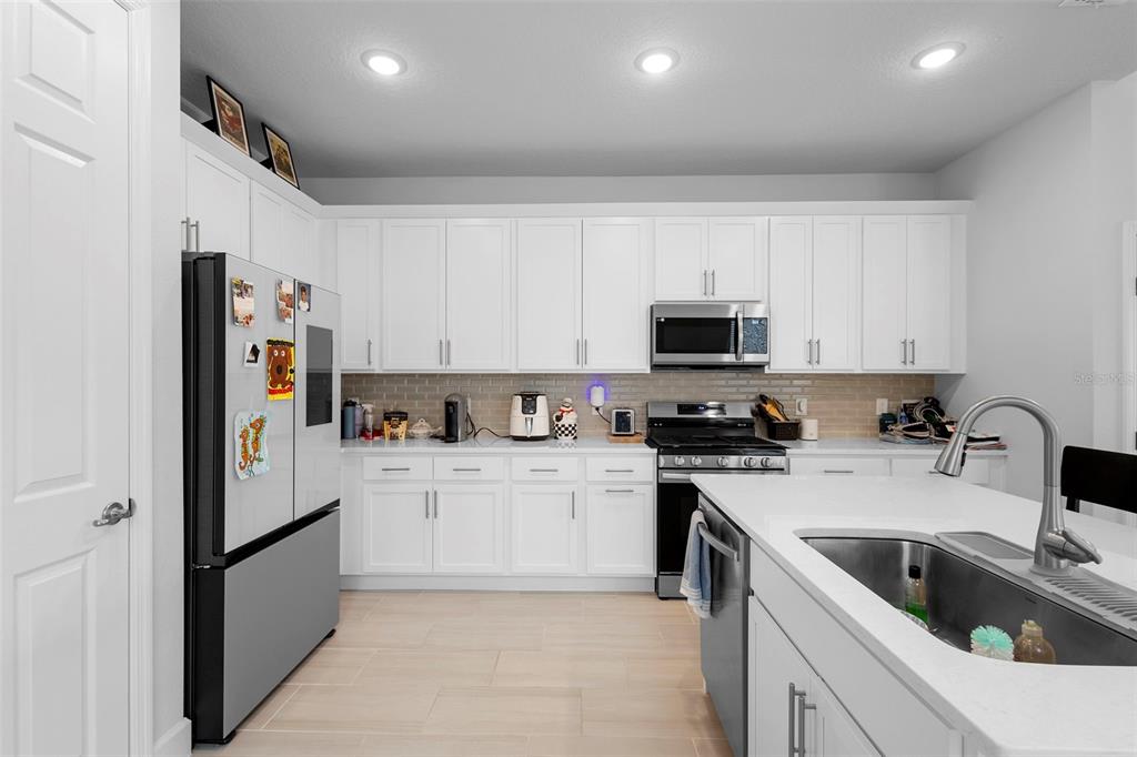269 Platform Lane DeBary, FL 32713 - Photo 20 of 41 a kitchen with stainless steel appliances granite countertop a refrigerator sink and stove