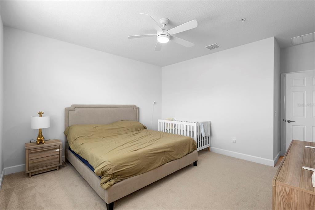 269 Platform Lane DeBary, FL 32713 - Photo 28 of 41 a bedroom with a bed and a chandelier