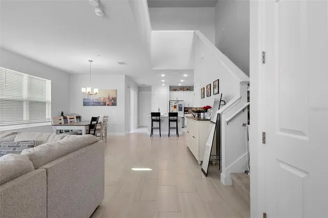 a view of living room with furniture and kitchen view