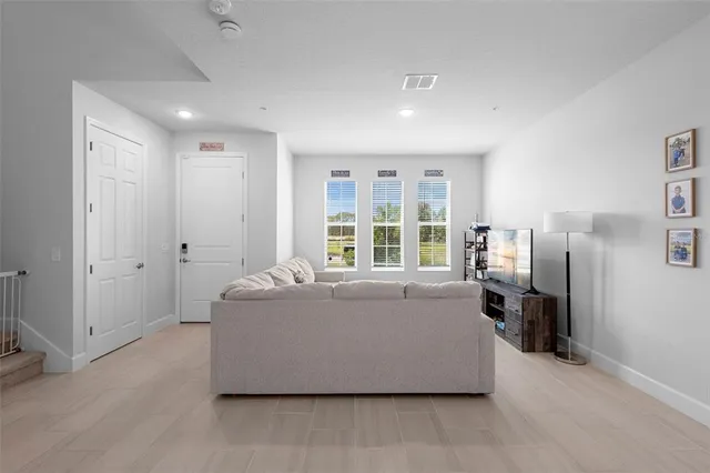 a living room with furniture and large window