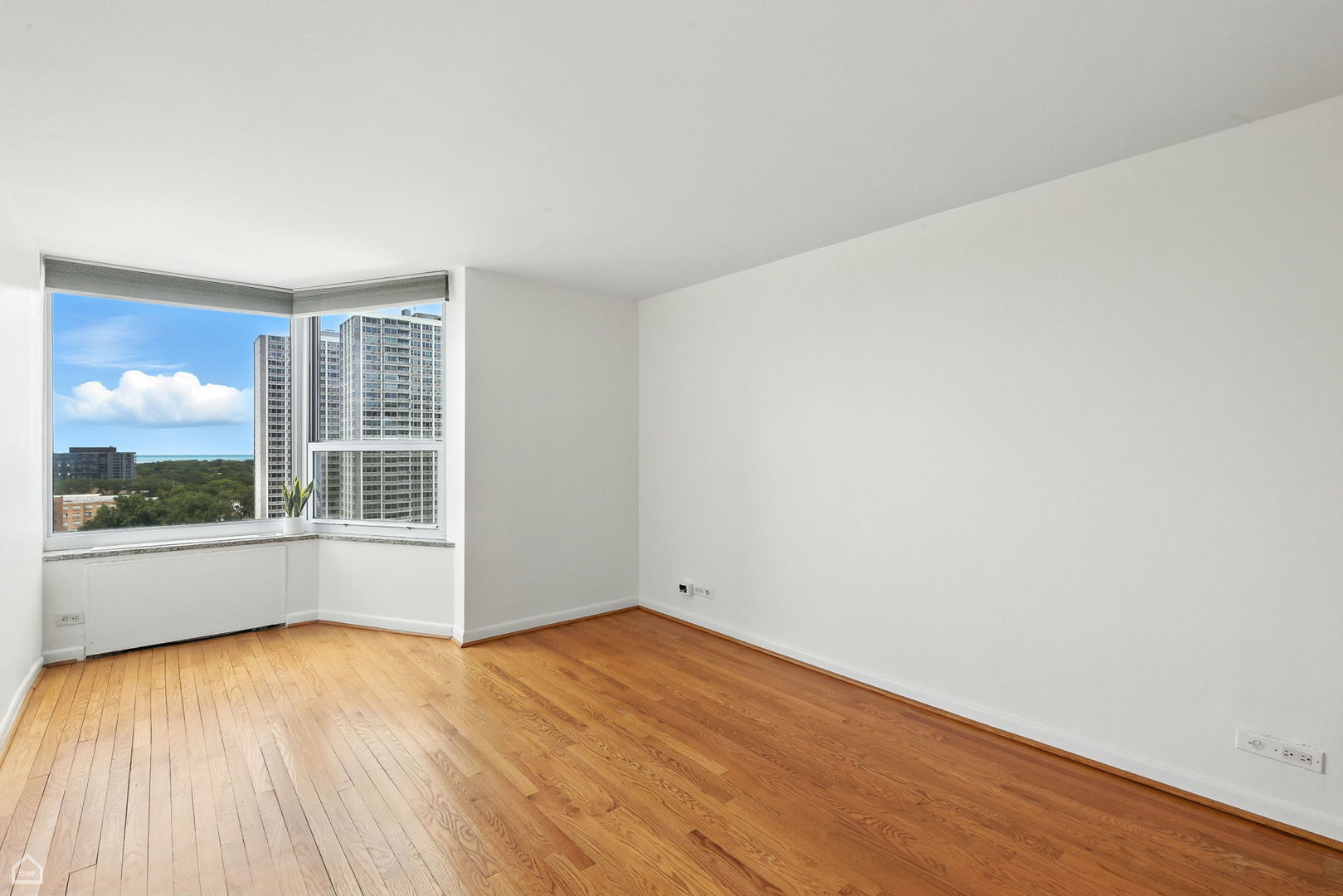720 West Gordon Terrace, Unit 16E Chicago, IL 60613 - Photo 16 of 34 an empty room with wooden floor and windows
