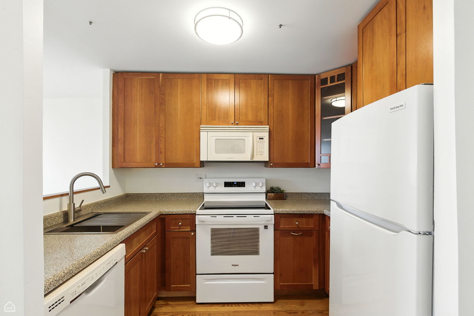 720 West Gordon Terrace, Unit 16E Chicago, IL 60613 - Photo 6 of 34 a kitchen with a refrigerator and a sink