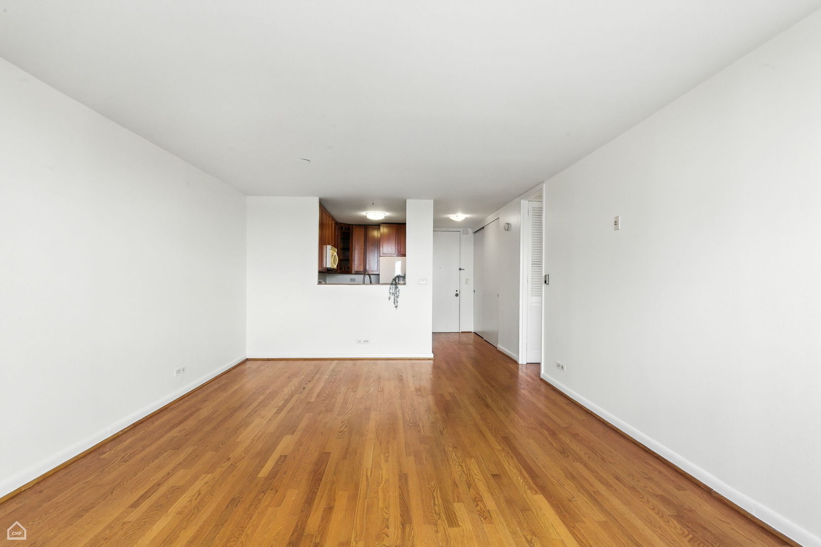 720 West Gordon Terrace, Unit 16E Chicago, IL 60613 - Photo 10 of 34 a view of empty room with wooden floor and fan