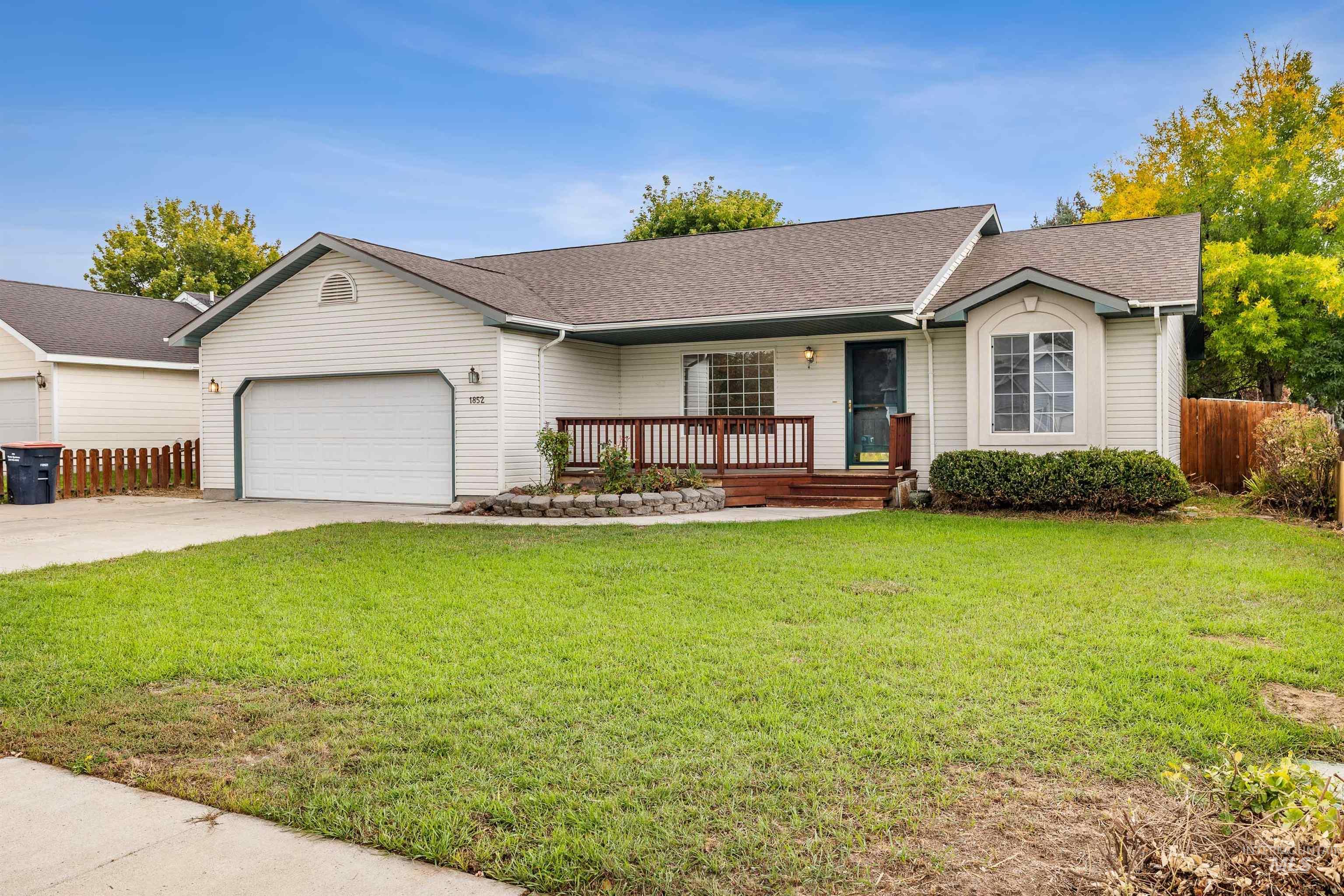1852 Spring Lane Twin Falls, ID 83301 - Photo 1 of 1 Ranch-style house with covered porch, roof with shingles, driveway, and an attached garage
