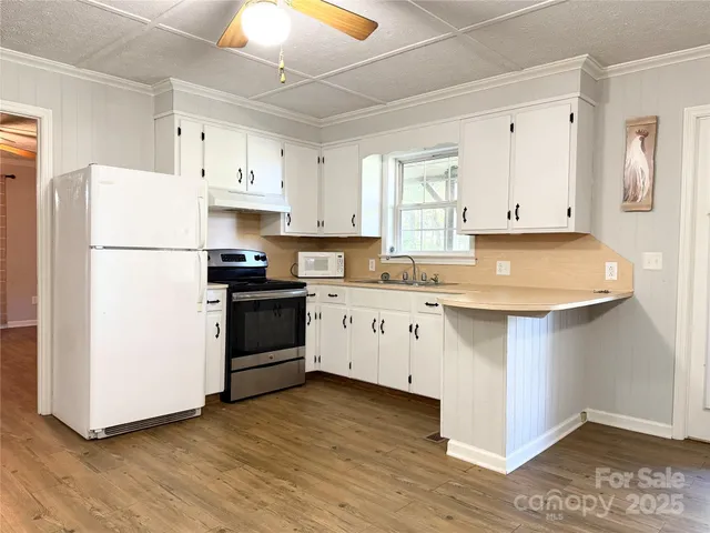 a kitchen with wooden cabinets and white appliances