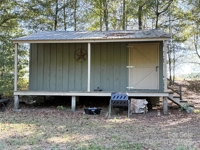 a view of a house with a yard and sitting area