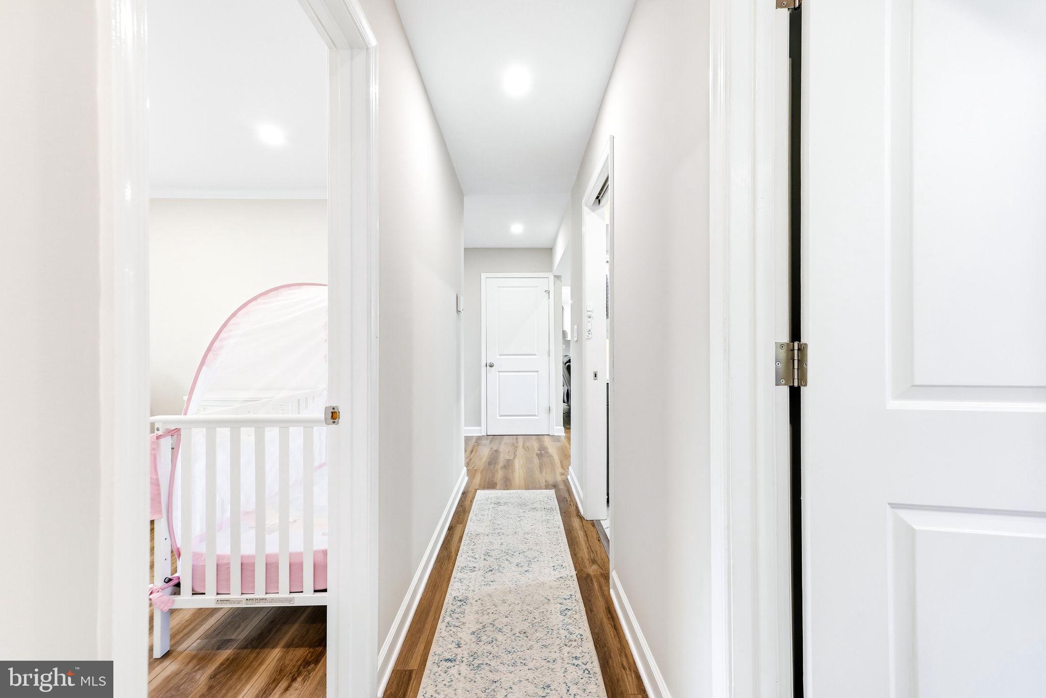 16932 Flickerwood Road Parkton, MD 21120 - Photo 27 of 64 a view of a hallway with wooden floor and staircase