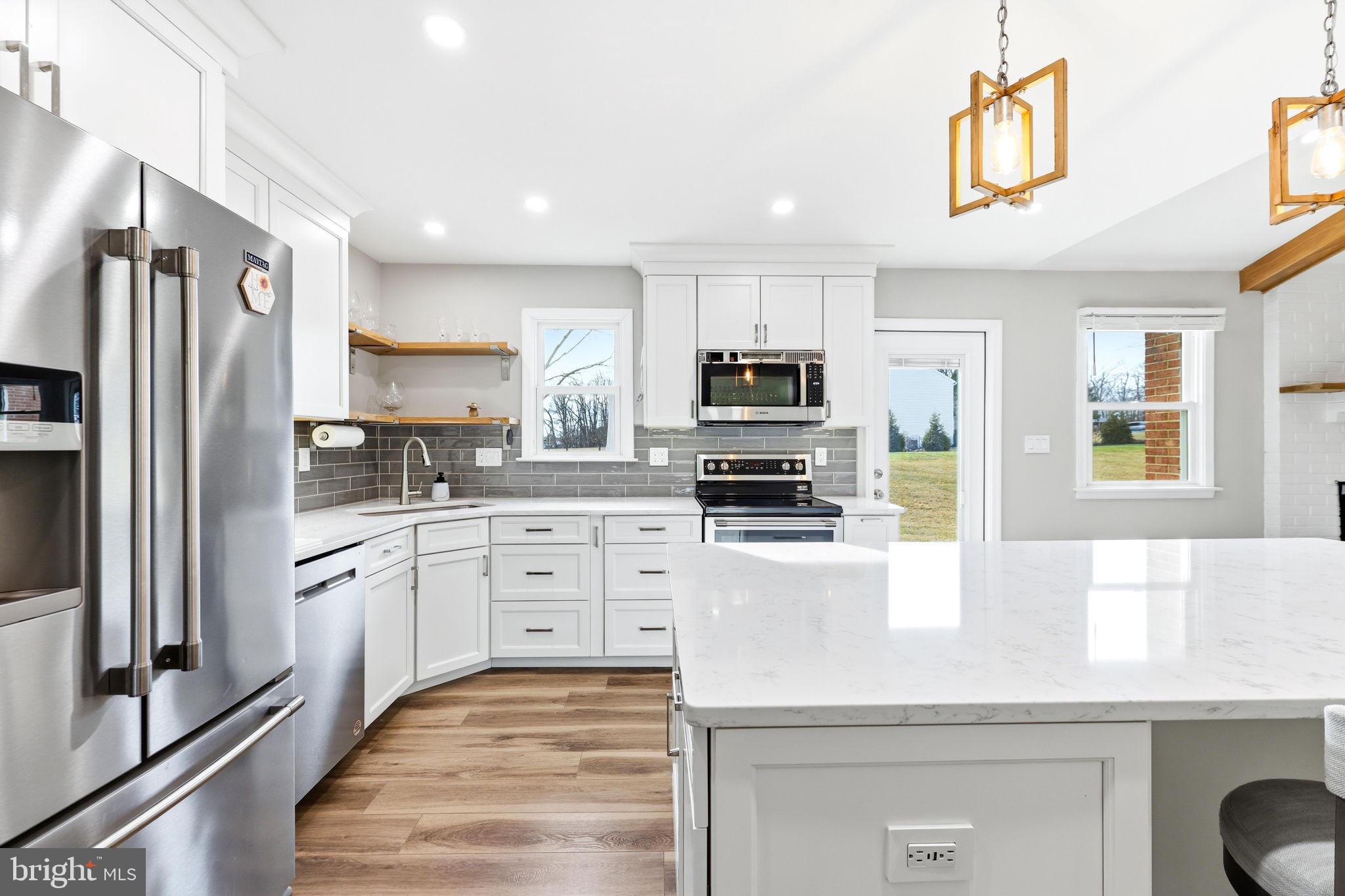 16932 Flickerwood Road Parkton, MD 21120 - Photo 3 of 64 a kitchen with granite countertop a refrigerator stove and sink