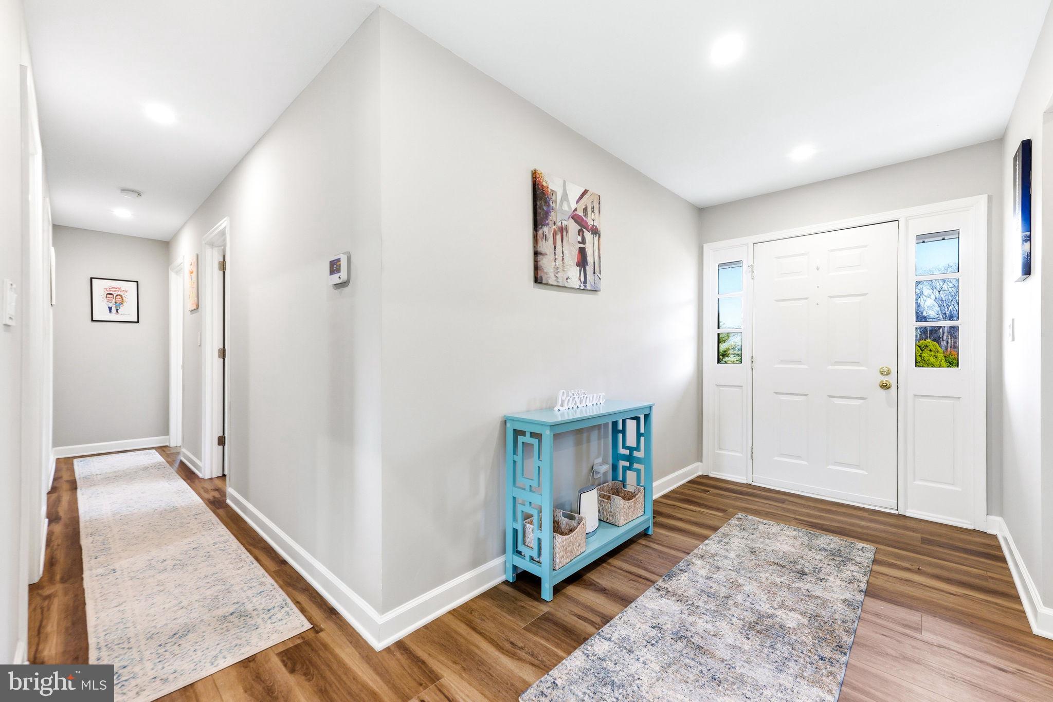 16932 Flickerwood Road Parkton, MD 21120 - Photo 9 of 64 a view of a hallway with bathroom and wooden floor