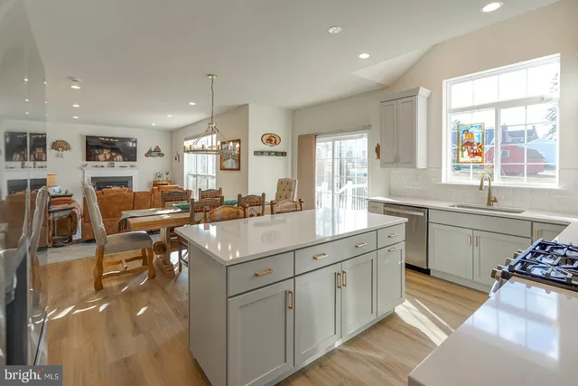 a kitchen with sink stove and cabinets