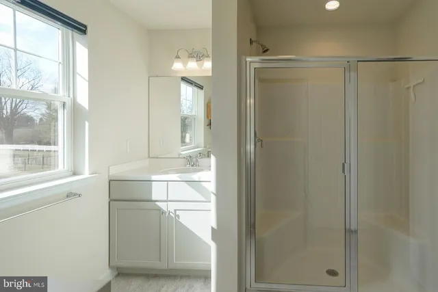 a room with a mirror and a shower