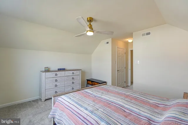 a bedroom with a bed and cabinets