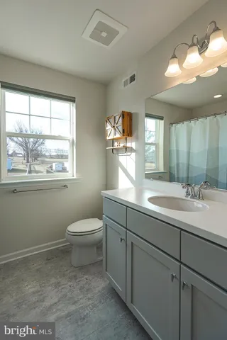 a bathroom with a toilet sink and mirror