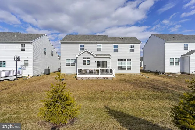 a large white house with a large pool of the house