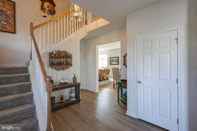 a view of entryway and hall with wooden floor