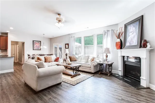a living room with furniture large window and a fireplace