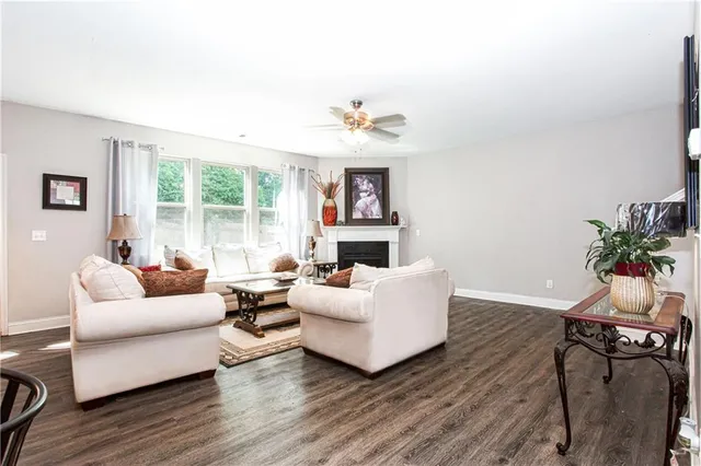 a living room with fireplace furniture and a wooden floor