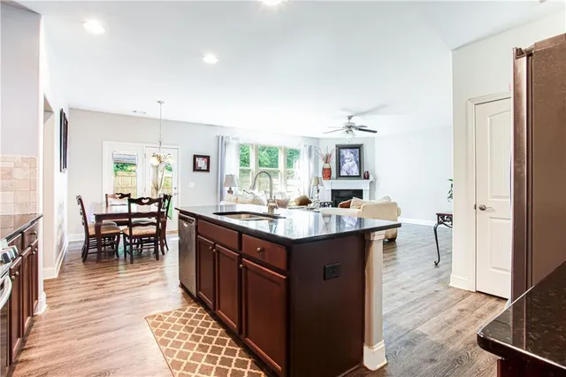 a kitchen with granite countertop a sink appliances and cabinets