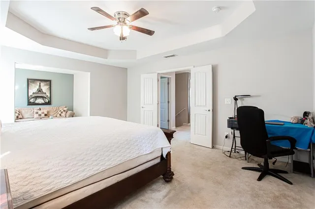 a bedroom with a bed and a chair