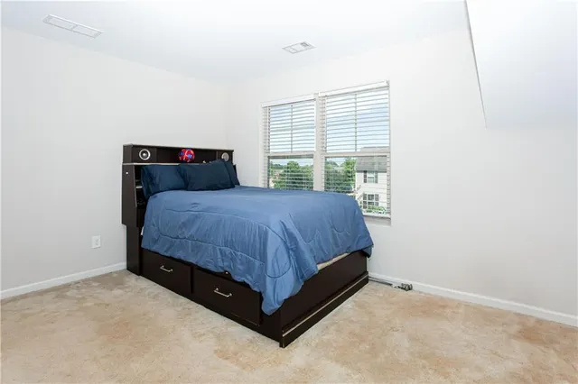 a bedroom with a bed and window