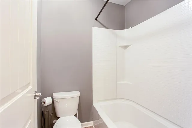 a white toilet sitting next to a bathroom sink and tub