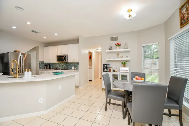 a kitchen with stainless steel appliances kitchen island granite countertop a sink and cabinets