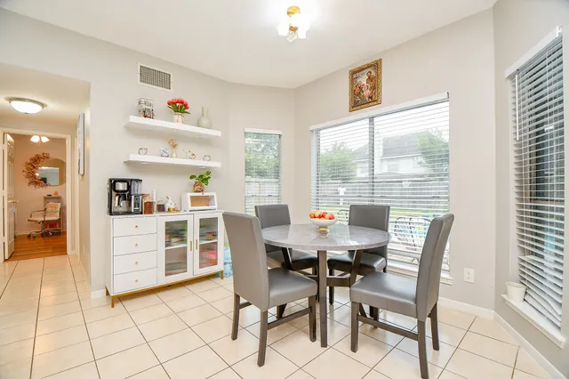 a view of a dining room with furniture and a window
