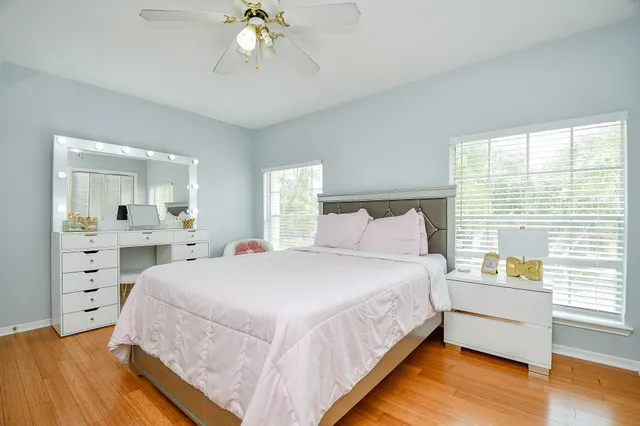 a bathroom with a granite countertop sink a toilet a mirror and shower