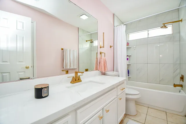 a view of a room with wooden floor and a bathroom