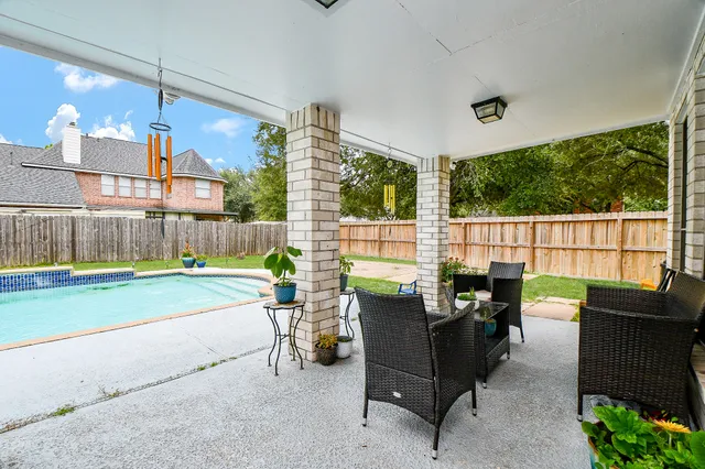 a view of a house with a yard and sitting area